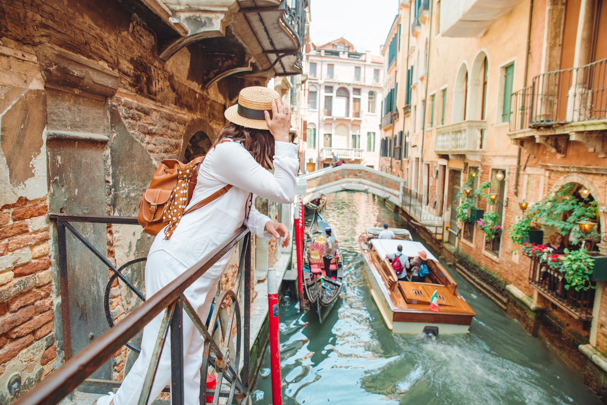 woman looking at canal with gandola woman looking at canal with gandola summer vacation